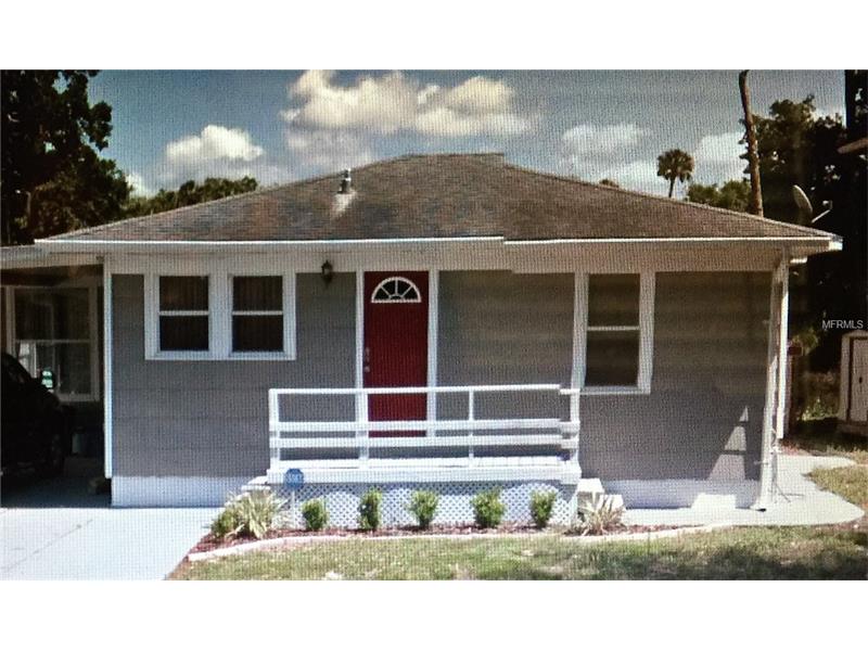 Small gray house with red door and porch